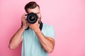 Portrait of concentrated man having summer vacation taking photo with his digital dslr camera wear modern stylish Royalty Free Stock Photo