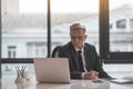 Focused retire male worker typing in gadget Royalty Free Stock Photo