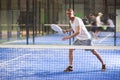 Concentrated paddle tennis player preparing to hit forehand Royalty Free Stock Photo