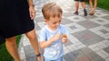 Portrait of little concentrated toddler boy playing with toy helicopter in park Royalty Free Stock Photo