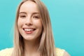 Portrait Concept: face of a beautiful young girl with a clean fresh face close up. over blue background. Royalty Free Stock Photo