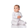 Portrait of a concerned child sitting in the studio on a white background.