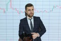 Portrait of concerned European businessman thinking in blurry office with double exposure of falling financial chart Royalty Free Stock Photo