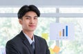 Portrait of Confidence Asian Business man Standing in front of a presenting board