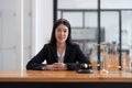 Portrait confidence asian lawyer looking on camera sitting at work desk in office.