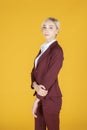 Portrait of confidence caucasian business woman on yellow background