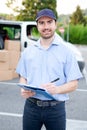 Portrait of confidence express courier and delivery van Royalty Free Stock Photo