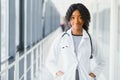 Portrait confident African American female doctor medical professional writing patient notes isolated on hospital clinic hallway Royalty Free Stock Photo