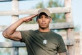 portrait of confident african american soldier in cap with tag dog