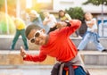 African boy dancing hip-hop with group of tweens on city street Royalty Free Stock Photo