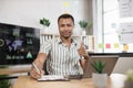 Portrait of confident african businessman in stylish formal wear writing notes using laptop Royalty Free Stock Photo