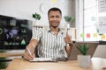 Portrait of confident african businessman in stylish formal wear writing notes using laptop Royalty Free Stock Photo