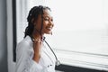 Portrait confident African female doctor medical professional writing patient notes isolated on hospital clinic hallway Royalty Free Stock Photo