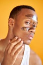 Portrait of confident afro american man with facial mask on T zone Royalty Free Stock Photo