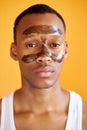 Portrait of confident afro american man with facial mask on T zone Royalty Free Stock Photo