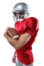 Portrait of confident American football player in red jersey holding ball Royalty Free Stock Photo