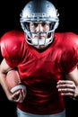 Portrait of confident American football player running while holding ball Royalty Free Stock Photo