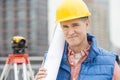 Portrait Of Confident Architect Holding Rolled Up Blueprint Royalty Free Stock Photo