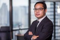 Portrait of confident asian business man in eyeglasses standing in offiec looking at camera Royalty Free Stock Photo