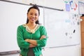 Portrait of confident Asian female teacher in classroom Royalty Free Stock Photo