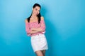 Portrait of confident asian lady hold arms crossed wear open shoulders shirt denim mini skirt isolated blue color Royalty Free Stock Photo