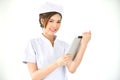 Asian nurse is smiling and holding digital tablet. Royalty Free Stock Photo