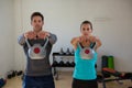 Portrait of confident athletes lifting kettlebells Royalty Free Stock Photo