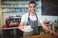 Portrait of confident barista serving coffee at cafe Royalty Free Stock Photo