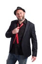 Portrait of confident bearded man with black suit, red tie and hat. People, style and fashion concept.