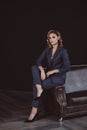 Portrait of a confident beautiful business woman in a suit on a dark background. The concept of gender equality. Strong Royalty Free Stock Photo