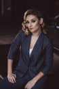Portrait of a confident beautiful business woman in a suit on a dark background. The concept of gender equality. Strong Royalty Free Stock Photo