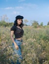 Portrait of confident beautiful woman wearing black hat and fashionable clothes looking at camera Royalty Free Stock Photo