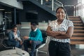 Portrait of a confident black businesswoman smiling with her arms crossed and all African team Royalty Free Stock Photo