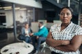 Portrait of a confident black businesswoman with her arms crossed and all African team Royalty Free Stock Photo