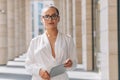 Portrait of a confident business girl looking at the camera. Businesswoman holds digital tablet in hand, stern look Royalty Free Stock Photo