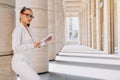 Portrait of a confident business girl looking at the camera. Businesswoman holds digital tablet in hand, stern look Royalty Free Stock Photo