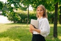 Portrait of confident business girl looking at the camera. Businesswoman holds digital tablet in hand Royalty Free Stock Photo