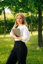 Portrait of a confident business girl looking at the camera. Businesswoman holds digital tablet in hand, stern look Royalty Free Stock Photo