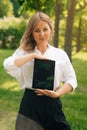 Portrait of a confident business girl looking at the camera. Businesswoman holds digital tablet in hand, stern look Royalty Free Stock Photo