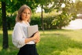 Portrait of a confident business girl looking at the camera. Businesswoman holds digital tablet in hand, stern look Royalty Free Stock Photo