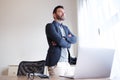 Confident business man standing in office with computer Royalty Free Stock Photo