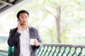 Portrait of a confident business man talking cell phone call outdoor. Royalty Free Stock Photo