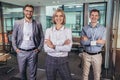 Confident business people standing together in the office Royalty Free Stock Photo