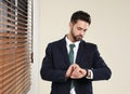 Portrait of confident businessman checking time at window Royalty Free Stock Photo