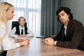 Portrait of confident businessman looking at camera with serious expression sitting at desk, during business meeting Royalty Free Stock Photo