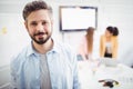 Portrait of confident businessman standing in meeting room at creative office Royalty Free Stock Photo