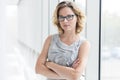 Portrait of confident businesswoman standing with arms crossed at new office Royalty Free Stock Photo