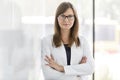 Portrait of confident businesswoman standing with arms crossed at office Royalty Free Stock Photo