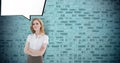 Portrait of confident businesswoman standing arms crossed with speech bubble against brick wall