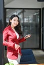 Confident businesswoman standing in office and smiling too camera. Royalty Free Stock Photo